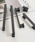 Matte Black Cabinet Handles 5 Inch 128mm Hole Centers Solid Zinc Alloy Drawer Pulls Pack Of 10 displayed on a table.