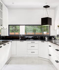 Modern kitchen with Matte Black Cabinet Handles 60 Pack With 3 Inch Hole Centers And 5 Inch Overall Length installed on white cabinets.