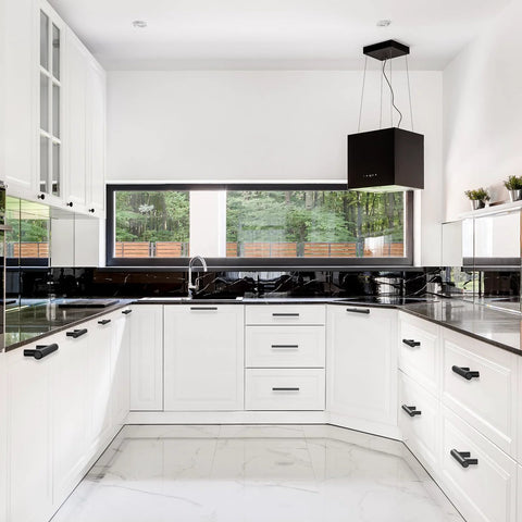 Modern kitchen with Matte Black Cabinet Handles 60 Pack With 3 Inch Hole Centers And 5 Inch Overall Length installed on white cabinets.