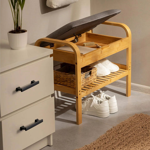 White cabinet featuring matte black cabinet handles with 5 inch 128mm hole centers in a room with bamboo bench and plants.