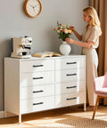 Woman arranging flowers on dresser with 3 Pack 5 Inch Center Hole Matte Black Kitchen Cabinet Handles Modern Cabinet Pulls installed