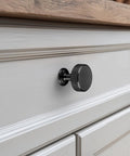 Close-up of matte black knob from 20-Pack Matte Black Cabinet Knobs For Kitchen Cabinets And Drawers, solid zinc alloy with brushed finish.