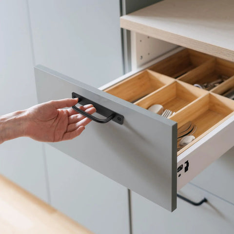 Opening a wooden drawer with 12 Pack Matte Black Aluminum Cabinet Pulls With Base Plate And Screws Five Point Eight Inch Length Barn Door Style