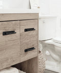 12 Pack Matte Black Aluminum Cabinet Pulls With Base Plate And Screws Five Point Eight Inch Length installed on bathroom cabinet