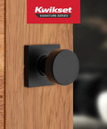 Non Locking Matte Black Interior Passage Door Knob With Microban Protection installed on wood door.