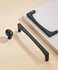 10 Pack Matte Black Oval Cabinet Knobs Single Hole Cabinet Pulls showcased with dresser unit, made of solid zinc alloy for modern home use.