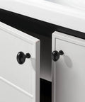 10 Pack Matte Black Oval Cabinet Knobs Single Hole Cabinet Pulls installed on white kitchen cabinets.