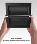 Hands showing Matte Black Recessed Toilet Paper Holder For Large Rolls Pivoting Wall Mount In Wall 304 Stainless Steel Rustproof