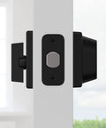 Side view of 660 Deadbolt Lock Matte Black Single Cylinder with keyed exterior, installed on a white door against a blurred background.