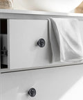 Matte Black Zinc Skull Cabinet Knobs For Drawers Doors And Furniture Hardware on white dresser with towel, two screw lengths visible