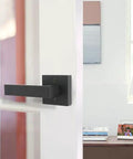 Matte Black Square Dummy Door Levers 4 Pack For French Doors And Closet Hardware installed on a white interior door.