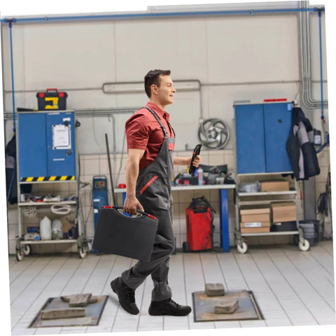 Mechanic holding DIY Friendly Car Bumper Repair Kit With Compact Hot Plastic Welder And LED Indicator, Portable Case in garage.