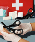 2 Pack Medical Trauma Shears For Left And Right Hand with Patented Bandage Scissors shown cutting bandage with first aid kit