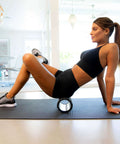 Woman using Medium Compression Foam Roller For Myofascial Release Massage With Three Texture Zones For Targeted Exercise Stretching And Muscle Recovery