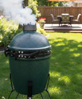 Outdoor scene with a Medium Green Egg grill featuring 2 pack hinge springs for Medium Green Egg grill 304 stainless steel replacement parts