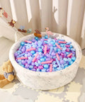 Ball Pit Balls - Pack of 200pcs Crush Proof Plastic Children's Toy Balls Mermaid Ocean Balls for Birthday Party Christmas Water Toy Indoor Outdoor,4 Shapes in a white pit with a teddy bear beside it.