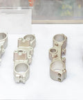Metal components displayed under glass showcasing aluminum oxide blasted finish