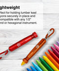Durable metal lumber crayon holder with an ambidextrous contoured grip, holding a yellow crayon among colored crayons.