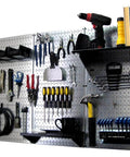 Wall Control Pegboard Organizer 4 ft. Metal Pegboard Standard Tool Storage Kit with tools and black accessories mounted on galvanized toolboard