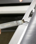 Compact Double End Metal Skin Wedge Prybar Tool By ARES, Ultra Thin 23 Gauge Ends used for panel removal on a car door.