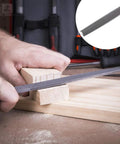 Man using Premium 17-piece file set in a rugged carry case, forged from T12 alloy steel, filing wood with engineer file.