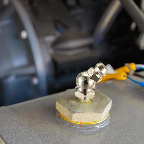 Close-up of installed zerk fitting from 60 Piece Metric Grease Fittings Kit for Grease Guns and Mechanical Lubrication Pro Grade Heavy Duty