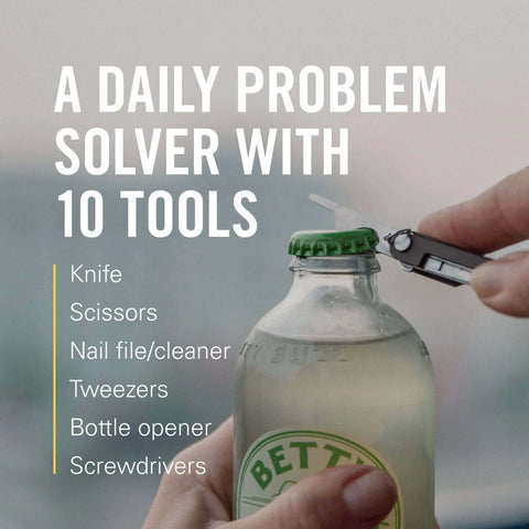 Leatherman Micra Keychain Multi Tool With Scissors And Knife opening a bottle, showcasing its compact stainless steel design.