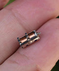 Close-up of 10Pcs DC 5V 2-Phase 4-Wire Micro Mini Ultra-Tiny 4 mm Precision Stepper Motor DIY held between fingers.