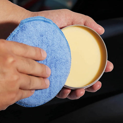 Person holding Microfiber Wax Applicator Pads For Car Detailing 5 Inch Foam Buffing Pads With Built In Sponge High Absorbency And Elastic Sponge Layer Ideal For Applying Waxes Polishes Protectants And Dressings 6 Pack next to car wax tin
