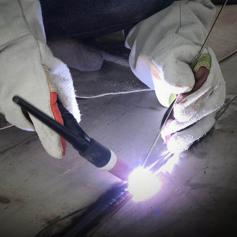 Welder using Mild Steel ER70S-6 Copper Coated Shielded Gas MIG Welding Rod for structural fabrication