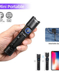 Hand holding Portable 395nm UV Flashlight Ultraviolet Black Light Mini USB Rechargeable With Metal Body next to phone and clip on jeans