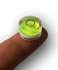 Four compact green round mini spirit levels with clear acrylic housings deliver precise bubble readings for tiny projects