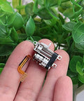 Close-up view of a 2-Pack Mini 5mm 2-Phase 4-Wire 3V 5V Planetary Gear Stepper Motor Linear Screw Slider held on fingertips.
