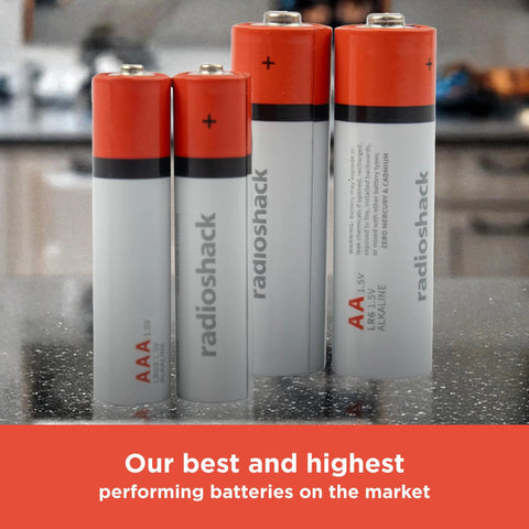 Close-up of four AA and AAA batteries standing on a counter, labeled as Mixed Alkaline Battery Pack 12 AA 12 AAA With Reusable Plastic Case.