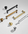 Assorted cabinet knobs and pulls including Champagne Bronze Cabinet Knobs Set of Ten, One and One Quarter Inch Round Zinc Alloy Drawer Knobs.