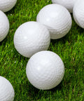 MLB Plastic Baseballs - 8 Pack on grass, showing perforated design for batting practice