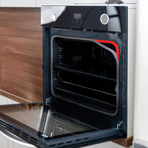 Open modern kitchen oven showing interior shelves and digital controls