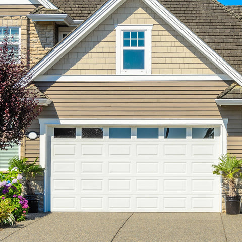 Front view of house with closed white sectional garage door, illustrating use of Bottom Lifting Brackets For Sectional Garage Doors, 7/16 Inch Roller