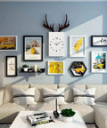 Living room with gallery wall display, featuring various framed art and clock, above a modern beige sofa and coffee table.