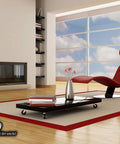 Modern living room with red chaise lounge, floor lamp, and coffee table on spacious wooden floor with large windows.