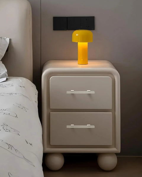 Nightstand with yellow lamp and drawers, featuring adjustable drawer pulls 5 pack in brushed nickel, modern square cabinet handles.
