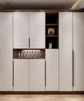 Five Pack Concealed Finger Pulls for Cabinets and Drawers in Black Aluminum, installed on modern white cabinets in a kitchen.