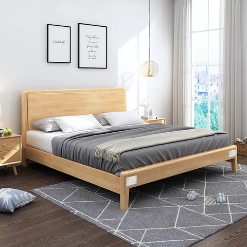 Modern bedroom with a wooden platform bed, gray bedding, and light wood nightstands, accented by a large window and wall art.