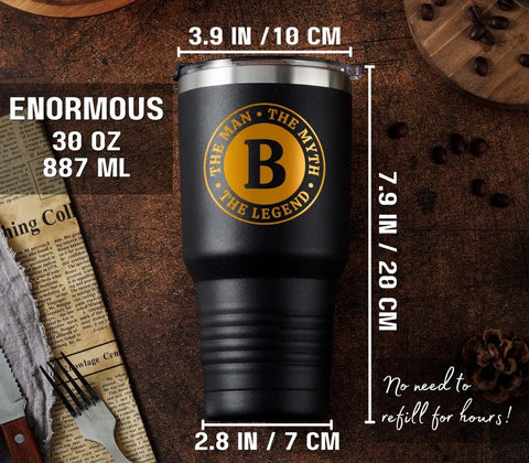 Man The Myth The Legend Monogram Stainless Steel Travel Tumbler For Men 30 Oz on a table with coffee beans and newspaper