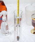 Moonshine Alcohol Hydrometer Kit 0 To 100 Proof With Glass Cylinder Brush And Dust Cloth for Home Distilling displayed on a counter.