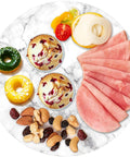 Marble lazy susan turntable designed as a cheese board and cake stand, 12 inch natural white marble rotating tray with food.