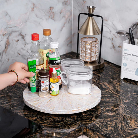 12.6 inch decorative lazy susan turntable with mother of pearl inlay, handcrafted tray displaying condiments on a kitchen counter.
