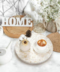 12 inch mother of pearl lazy susan turntable with marble pattern used as a decorative tray for coffee and flowers on a tabletop.