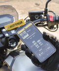 Motorcyclist using Bluetooth app on phone to control Essentials Micro XSystem 3.0 Plus Electronic Automatic Motorcycle Chain Lubrication System.