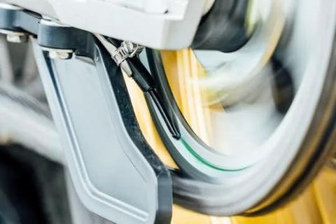 Close-up of Micro XSystem 3 Point 0 Plus Electronic Automatic Motorcycle Chain Lubrication System with dual injector in use